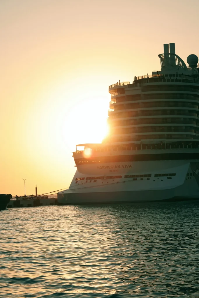 A cruise liner at the quay with the sun setting behind it