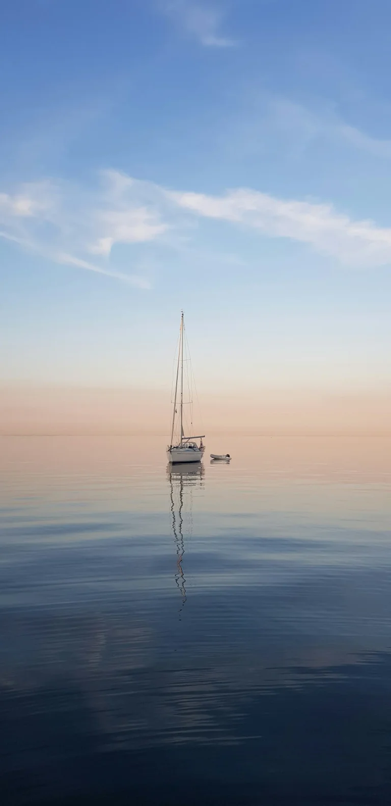 Sailing yacht on a calm sea at dusk