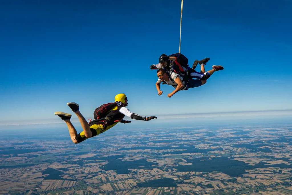 Skydivers in freefall above farmland