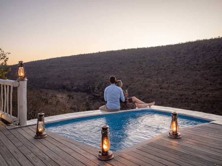 Guests relaxing by the plunge pool at sunset