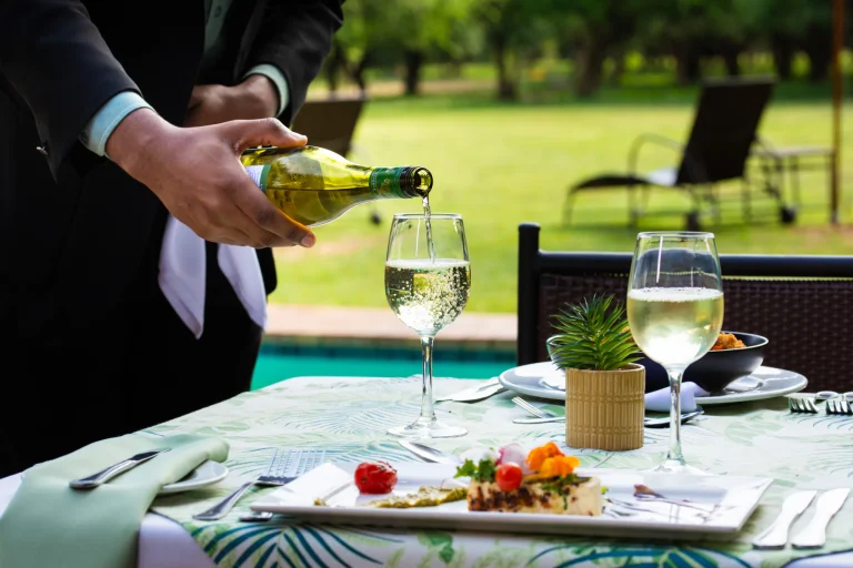 Wine served at a poolside table at Falaza