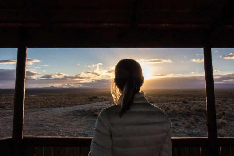 Guest watching the sunset over the Karoo from the lodge