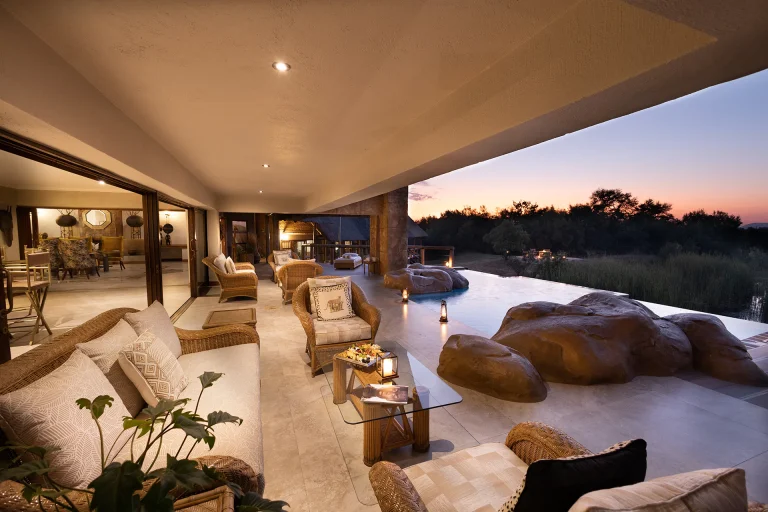 Lounge opening onto the pool and bush at sunset