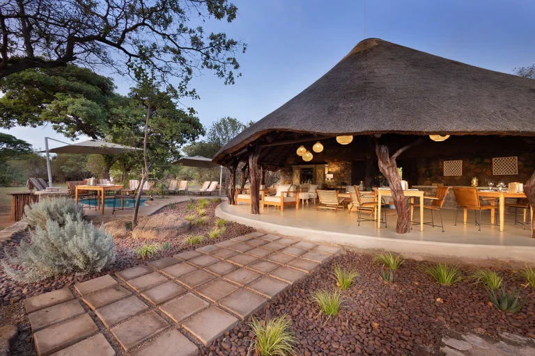 Thatched main lodge and pool deck at Kwafubesi