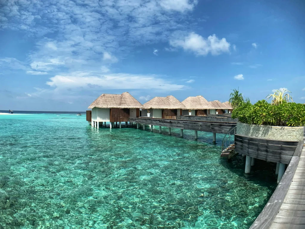 Overwater villas above a clear Maldives lagoon