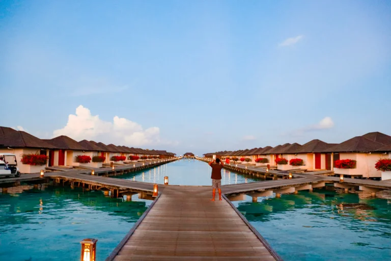 Wooden jetty between rows of overwater villas in the Maldives