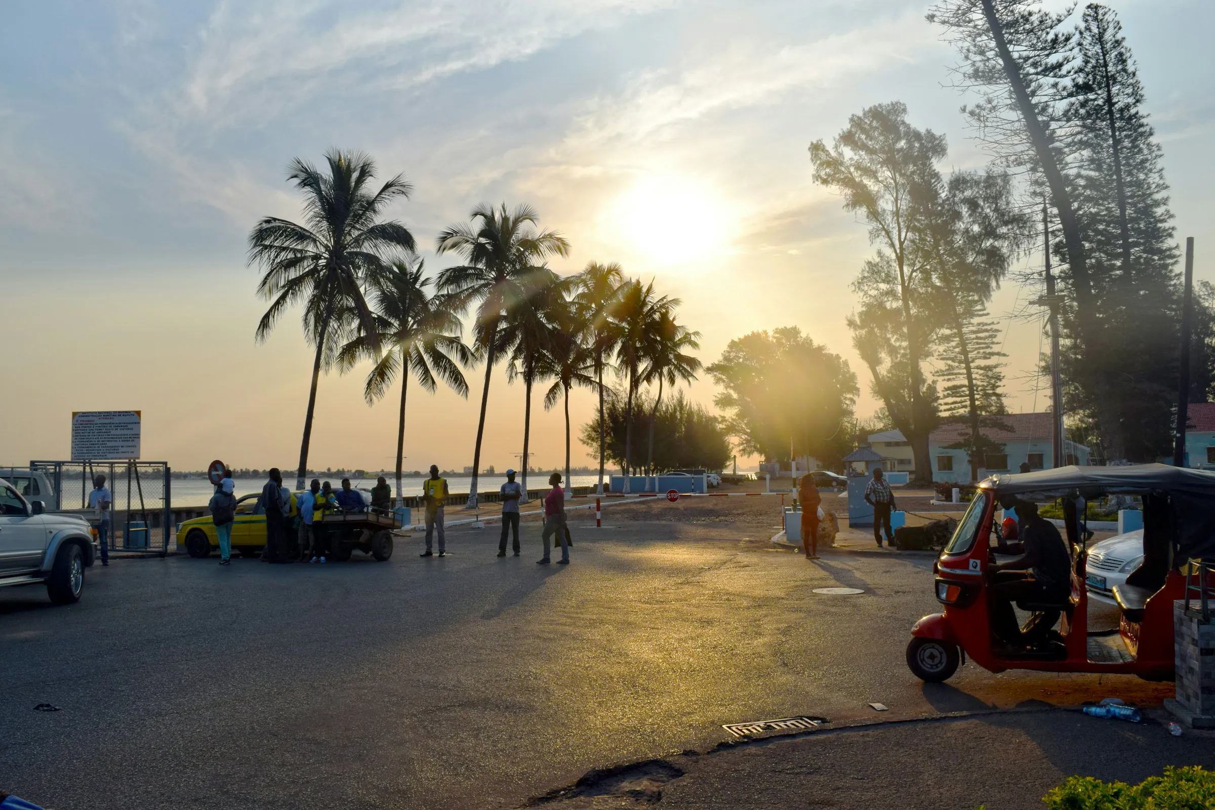 Palm-lined seafront road in Maputo at sunset