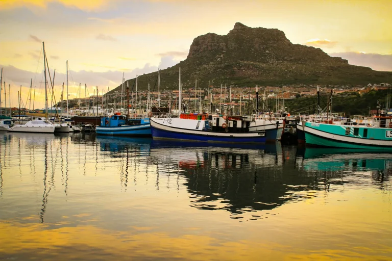 Harbour boats at sunset below the mountains