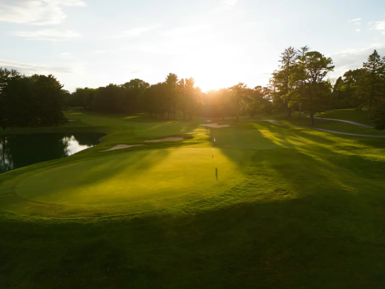Morning sun over a golf green and fairway