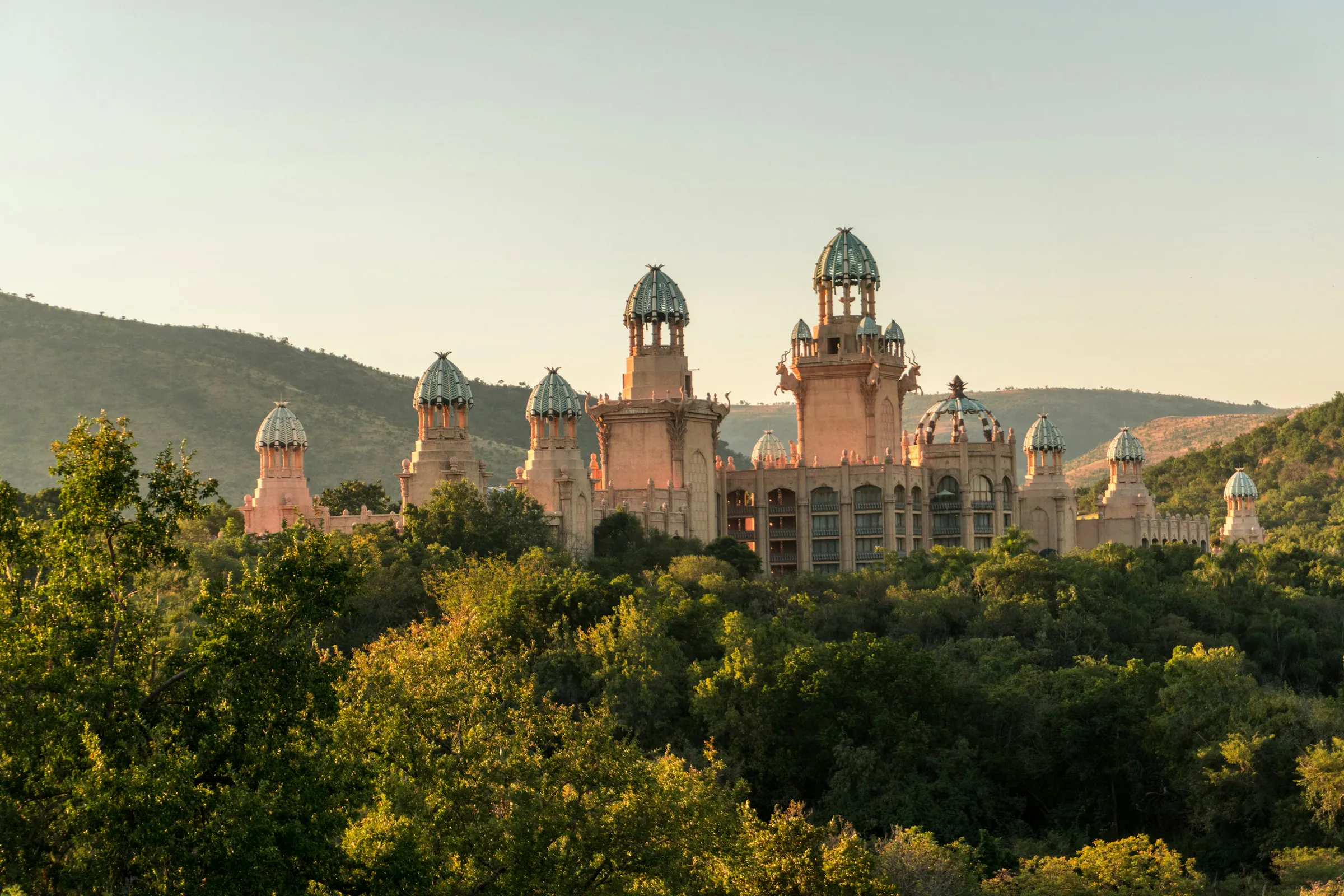 The Palace of the Lost City at Sun City rising above the bush at sunset