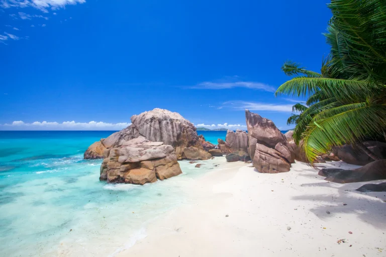 Granite boulders and white sand on a Seychelles beach