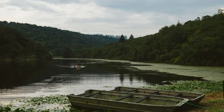 Canoes on a forest-fringed lake at Mufindi Highlands Lodge