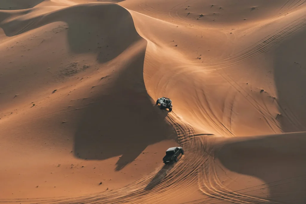 Quad bikes crossing sweeping dunes