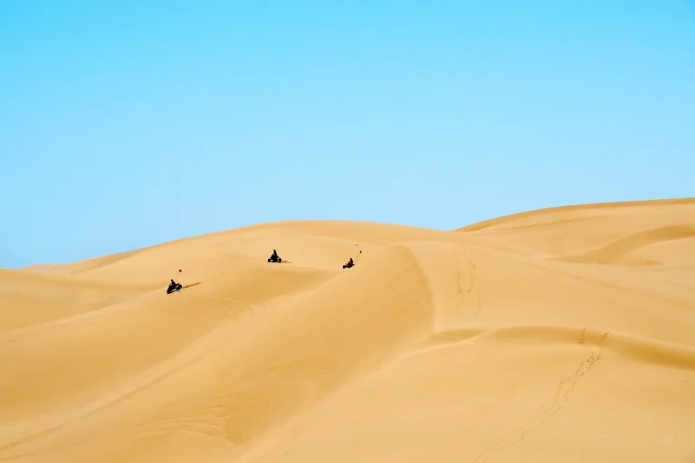 Riders on the crest of a sand dune